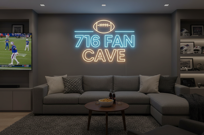 “716 Fan Cave” Game Room / Man Cave

Use for: second image in gallery, speaks directly to Buffalo locals.

Prompt:

Ultra-realistic image of a Buffalo fan game room featuring a bold custom LED neon wall sign. The sign says “716 FAN CAVE” in all caps, top line in bright icy blue block letters, bottom line in warm white, with a minimalist football icon in neon above the text. Mounted on a matte dark grey wall behind a big-screen TV, with a sofa, small table with snacks, and a couple of throw pillows in neutra